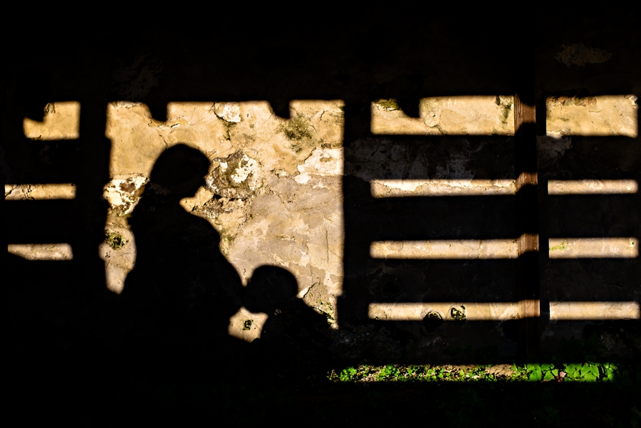 A silhouette of a pregnant couple in a farm house outside of philadelphia.